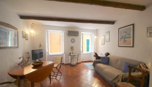 a living room with a couch and a table at La casa nel cuore di Camogli in Camogli