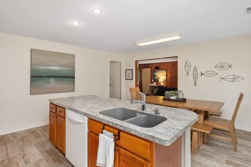 a kitchen with a sink and a counter top at HOT TUB - Grand Haven/Spring Lake Waterfront Home in Spring Lake