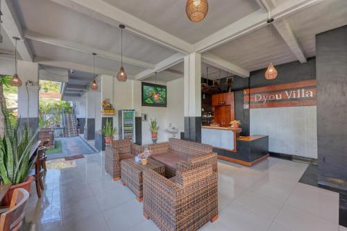 a restaurant with brown wicker chairs and a bar at Dyou Villa in Nusa Penida