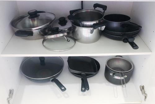 three pots and pans on a shelf in a kitchen at Beachfront 2br 2bath apartment private plunge pool 50 meter to Naithon beach in Nai Thon Beach