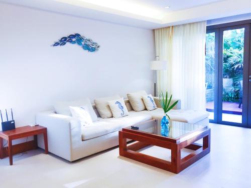 a living room with a white couch and a table at Beachfront 2br 2bath apartment private plunge pool 50 meter to Naithon beach in Nai Thon Beach