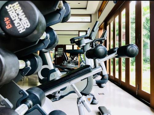 a row of exercise bikes in a gym at Beachfront 2br 2bath apartment private plunge pool 50 meter to Naithon beach in Nai Thon Beach