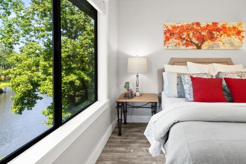 a bedroom with a bed and a large window at Condo at the Lakes in Charleston