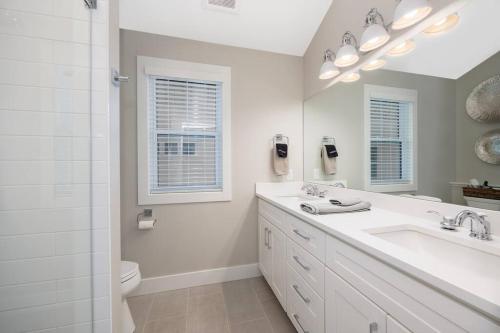 a bathroom with a sink and a toilet and a mirror at Hot Tub - Saugatuck - Douglas - Luxury Home Sleeps 8 in Douglas