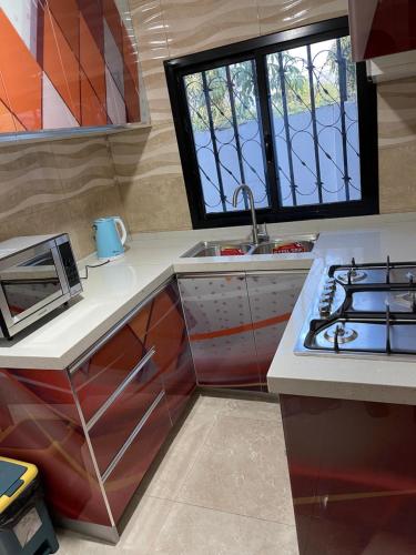 a kitchen with a stove top oven next to a sink at Holiday home in Lamin