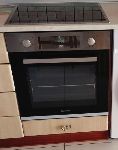 a microwave oven sitting inside of a kitchen at Periklis House in Ixia