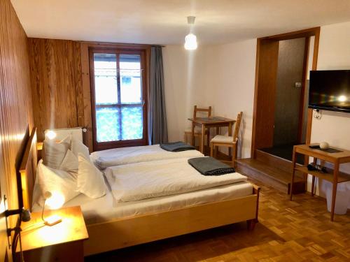 a hotel room with a bed and a window at Haus Huber in Bad Hindelang