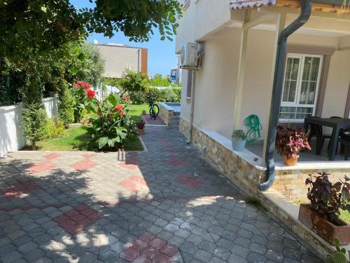 a brick walkway outside of a house with flowers at Orange&Lemon Villas Çamyuva in Kemer