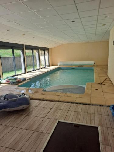 - une grande piscine dans une pièce dotée de fenêtres dans l'établissement Les lutins rêveurs, à Montagny-près-Louhans
