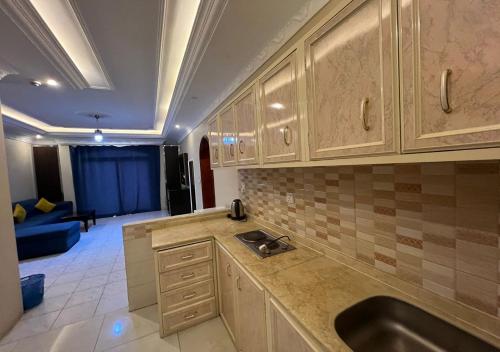 a kitchen with a sink and a couch in a room at فندق نسيم أبها in Abha