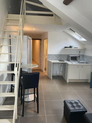 une cuisine avec un escalier et une table dans une pièce dans l'établissement Appartements sympas et confortables, à Nanterre