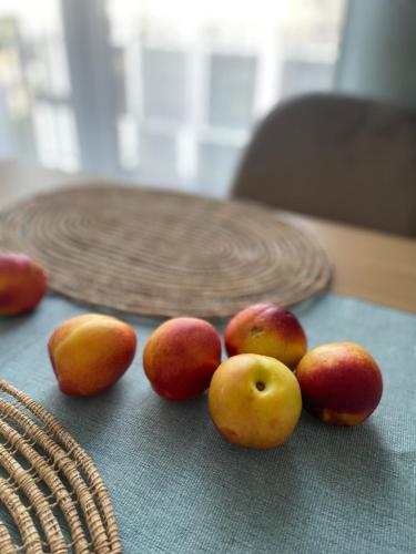 a group of apples and peaches on a table at LeHome Airport Wroclaw in Wrocław