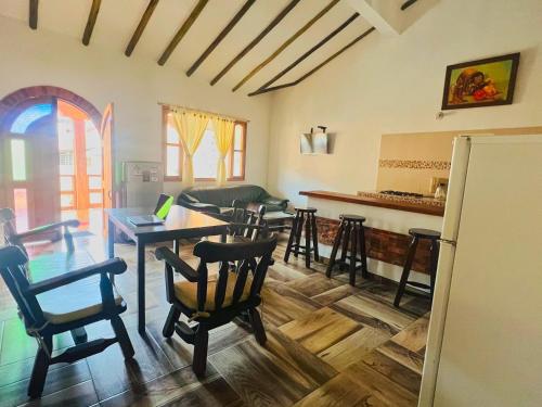 a kitchen and living room with a table and chairs at Villa villa in Villa de Leyva