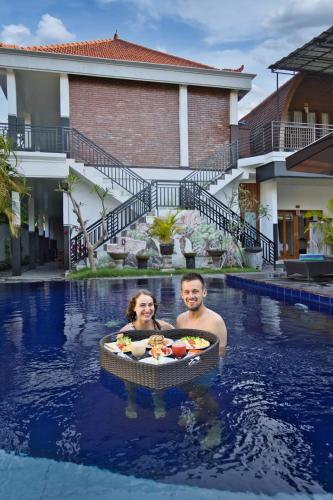 a man and a woman in a swimming pool at Dyou Villa in Nusa Penida