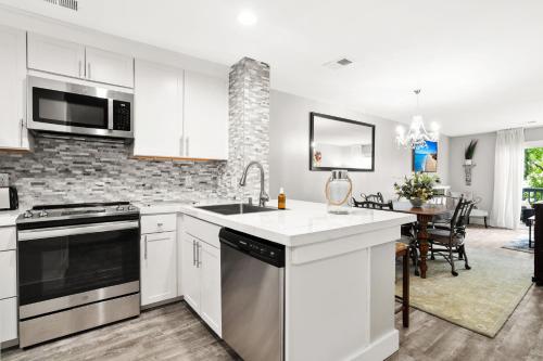 a kitchen with a sink and a stove top oven at Condo Serenity in Charleston
