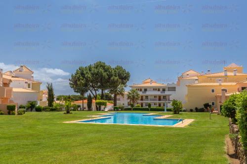 a villa with a swimming pool and a yard at Jardins de Santa Eulália By Albufeira Rental in Albufeira
