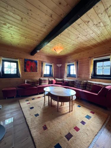 a living room with a couch and a table at Panorama View Apartments Nassfeld in Hermagor