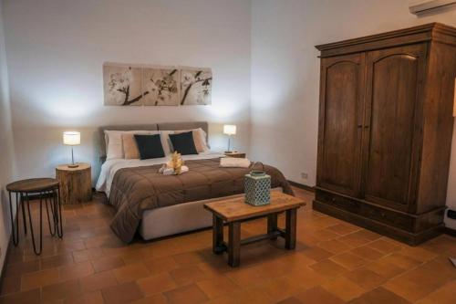 a bedroom with a large bed and a wooden cabinet at villa palmi in Agrigento