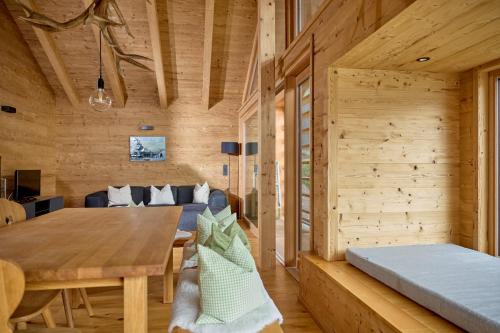 a dining room and living room in a log cabin at DESIGN-CHALETS by Pferd auf Wolke NEU in Gaschurn