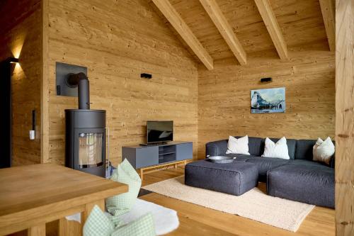 a living room with a couch and a fireplace at PLUENGGAS-CHALETS in Gaschurn