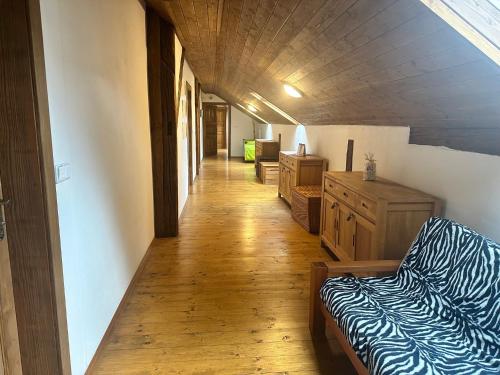 a hallway of a room with a bed and wooden floors at Slezský Grunt in Háj ve Slezsku