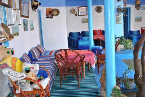 a room with chairs and a table in a room at Ferme Dar Aicha green Bellouta 