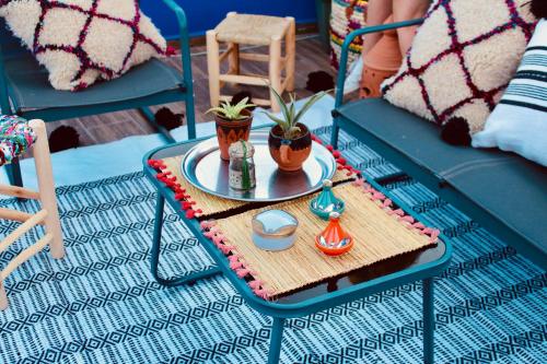 a table with a tray with two plants on it at TRAVEL SURF NATURE in Tamraght Ouzdar