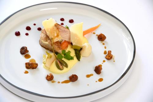 a plate of food with meat and vegetables on it at Château de Pizay in Belleville-sur-Saône