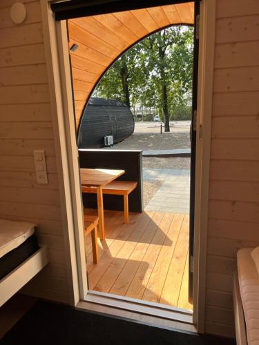 an open door of a cabin with a wooden deck at Helle Aktivitetshotel in Årre