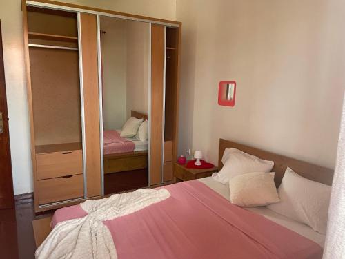 a bedroom with a bed and a large mirror at Tarrafal House in Tarrafal
