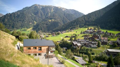 a village in a valley with mountains in the background at DESIGN-CHALETS by Pferd auf Wolke NEU in Gaschurn