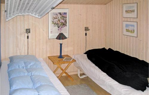 JerupにあるNice Home In Jerup With 4 Bedrooms, Sauna And Wifiのベッドルーム1室(ベッド1台、ランプ付きテーブル付)