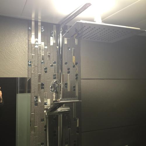 a bathroom with a shower with a glass wall at Seasons Hotel - Causeway Bay in Hong Kong
