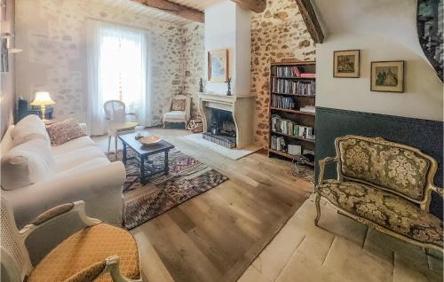 a living room with a couch and a fireplace at Lovely Home In Cazouls-Lès-Béziers in Cazouls-lès-Béziers