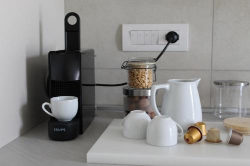a kitchen counter with a coffee maker and a blender at Bene39 in Turin