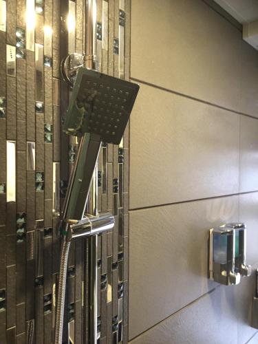a phone hanging on a wall in a bathroom at Seasons Hotel - Causeway Bay in Hong Kong