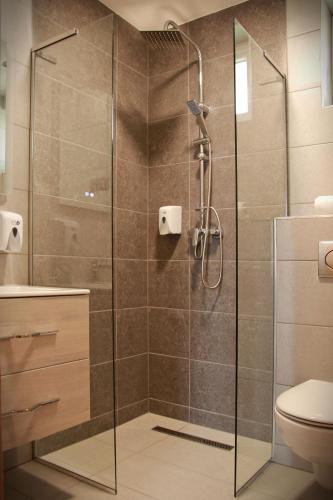 a shower with a glass door in a bathroom at Sunset Bogács in Bogács
