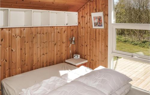 a bedroom with a bed and a window at Nice Home In Strandby With Kitchen in Strandby