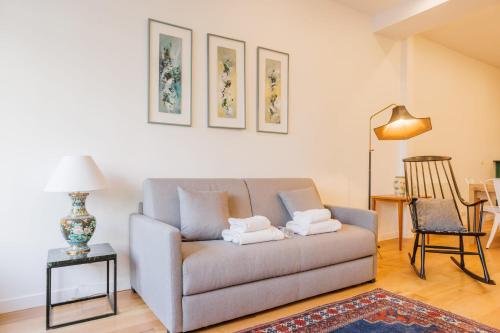 a living room with a couch and a table at Cosy Loft between Montparnasse & Luxembourg Gardens in Paris