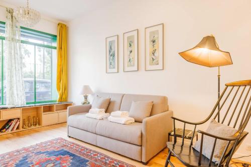 a living room with a couch and a table at Cosy Loft between Montparnasse & Luxembourg Gardens in Paris