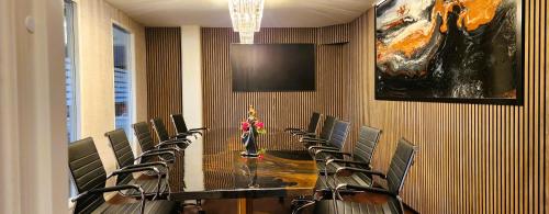 a conference room with a long table and chairs at Vänerport Lakefront Hotell in Mariestad