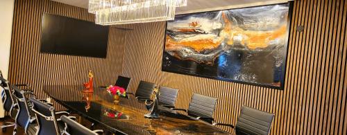 a conference room with a large painting on the wall at Vänerport Lakefront Hotell in Mariestad