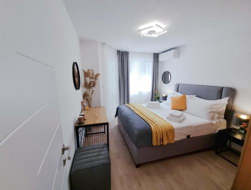 a bedroom with a bed and a couch in it at Nova City Apartments in Varna City