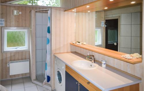 a bathroom with a sink and a mirror at 3 Bedroom Awesome Home In Sby in Nordost