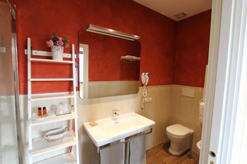 a bathroom with a sink and a toilet at Area Sacra Relais in Rome