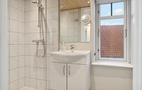 a white bathroom with a sink and a shower at Beautiful Home In Nysted With House Sea View in Nysted