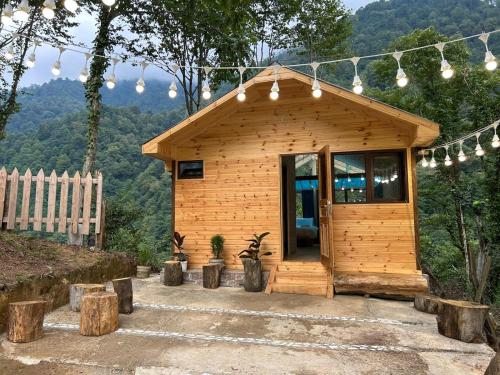 a small wooden cabin with a large glass door at SkyDoor_ცისკარი in Batumi