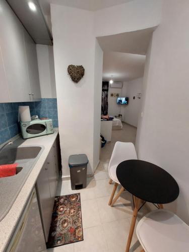 a kitchen with a sink and a table and chairs at Anastasia1 apartments in Thessaloniki