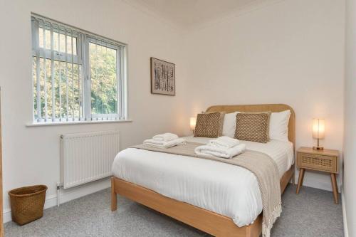 a bedroom with a bed with two towels on it at The Penthouse In Bonchurch Village by Greenstay Serviced Accommodation - Stunning 3 Bed Apt With Parking & Sea Views - The Perfect Choice For Families, Small Groups & Business Travellers in Ventnor