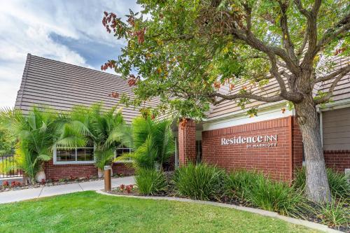 a red brick building with a sign for the residence inn at Residence Inn Sacramento Rancho Cordova in Rancho Cordova